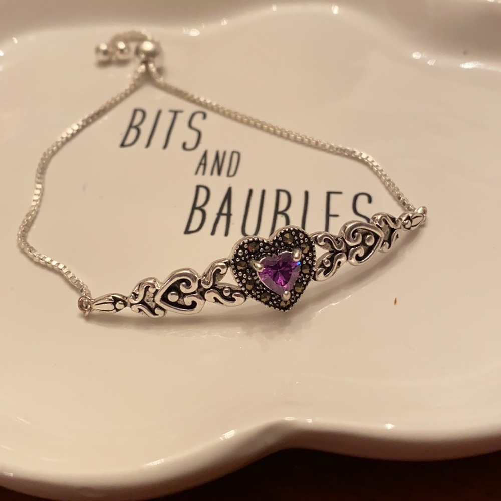 Adjustable silvertone bracelet with purple stone